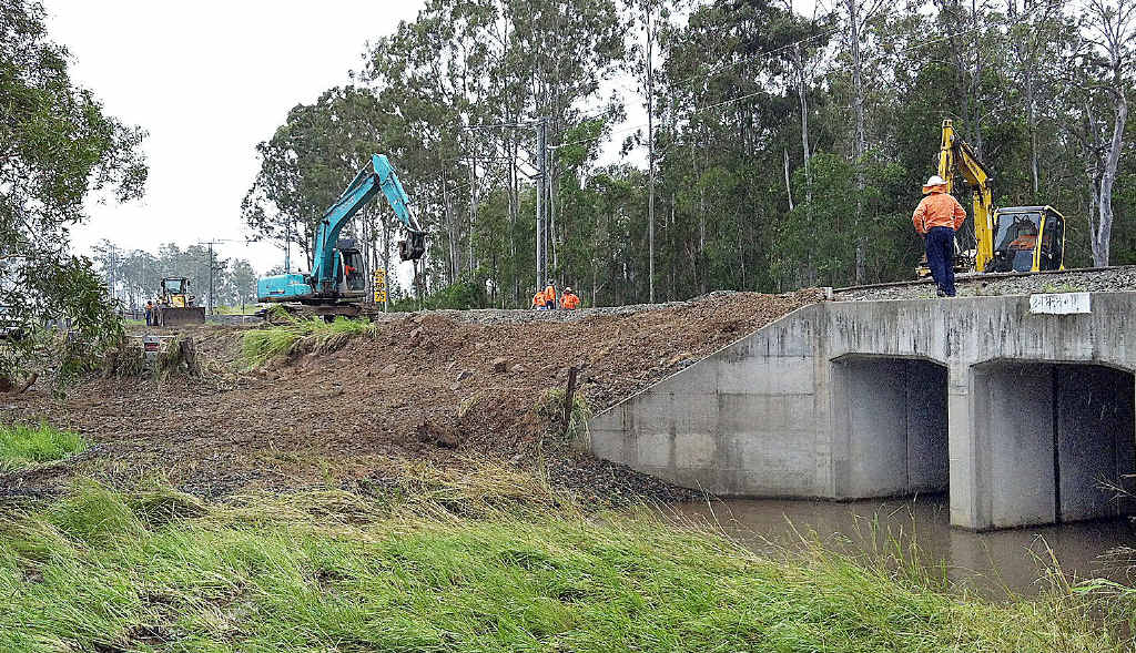 Workers repair the railway line at Owanyilla. Workers repair the railway line at Owanyilla.